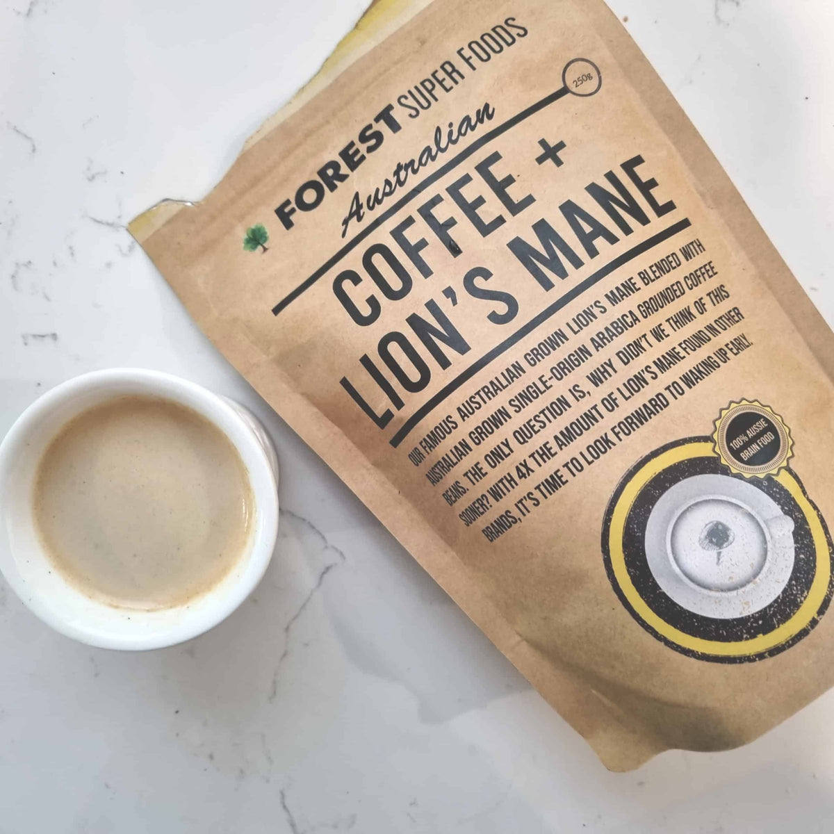 Australian Coffee + Lions Mane Mushroom kraft pouch with cup of smooth brewed coffee by Forest Super Foods